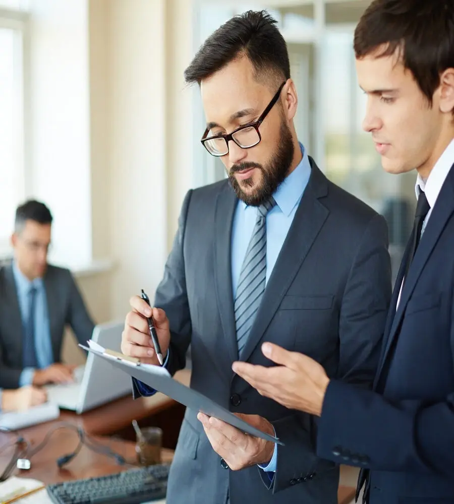 two-young-businessmen-with-report-900x1000 2 (1)
